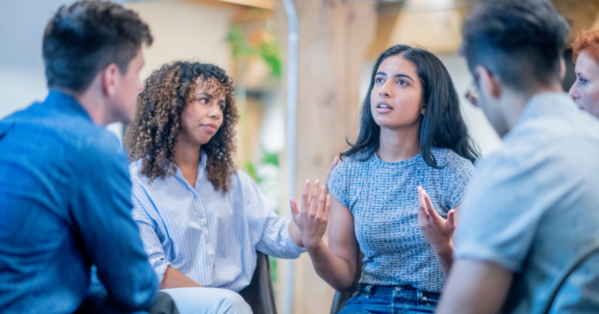 A diverse church small group sitting in a circle and talking, demonstrating the key practices of a great small group leader.