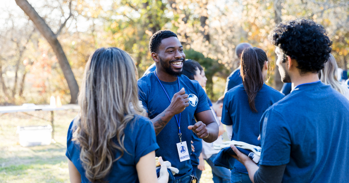 A healthy church volunteer leading a discussion with his team, illustrating the positive effects of delegation and preventing burnout.